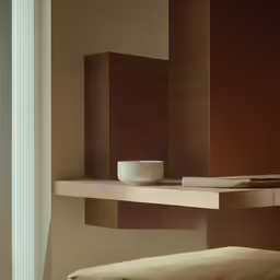 the shelf in this room holds a cup and napkins