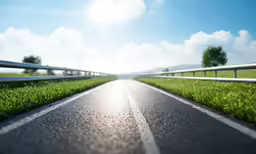 long road with metal guard rails going into the distance