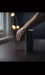 a hand holding onto a tin can with an empty cup