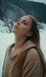 a beautiful young lady looking up in the air