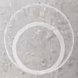 two glass rings sitting in a sand ground