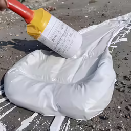someone is using a glue gun to paint a white cover