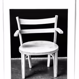 a wooden chair against a black background