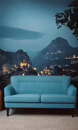 the light blue sofa is in front of the scenic view of the town