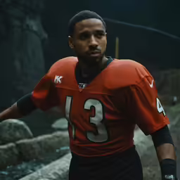 a close - up of a young man in an orange jersey