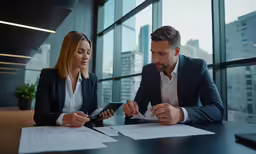 two business people looking at documents on a table