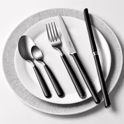 a set of silverware and spoons on a plate