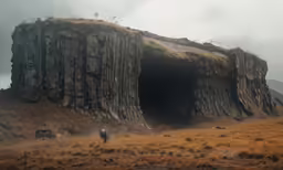 a man is standing in the open air near a rock