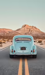 a blue classic car is sitting in the middle of a highway