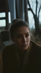 a woman is dressed in traditional clothing looking into the distance