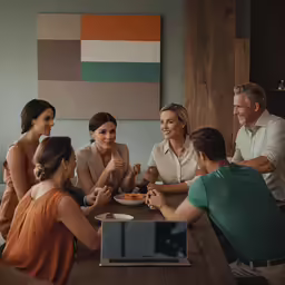 a group of people sitting around a wooden table