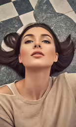 a woman laying on her side with her long hair