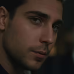 a man looking into the camera with a serious look