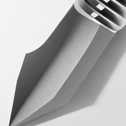 the grey, curved surface of a modern lamp