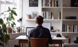 a person sitting at a desk with a computer