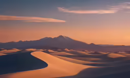 a sky view of sand dunes and mountains