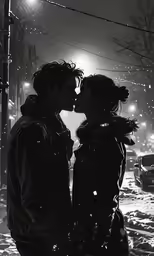 two people in black and white kissing in the snow