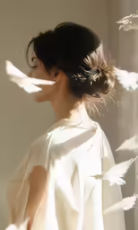 the woman stands in front of an image of birds flying through her hair