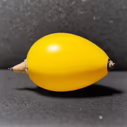 an orange banana with some brown spots on it