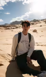 a man sitting on top of the desert