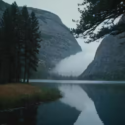 the mountain is next to the lake with water