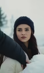 a person looking off into the distance in a snowy landscape