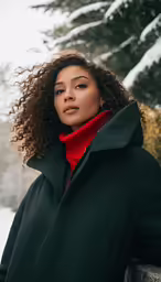 a woman is standing in the snow wearing a green coat