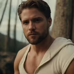 man in sleeveless tank top standing by trees
