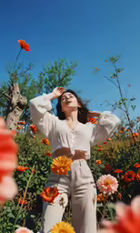 a woman standing in the middle of a field