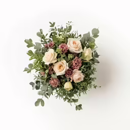 a bouquet of different flowers sitting on top of a table