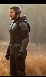 a man wearing a black suit and helmet