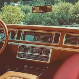 the interior of a vintage sports car with a stereo and control panel