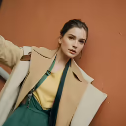 a young woman leaning against a wall