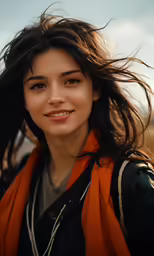 a woman with long hair and an orange scarf