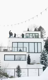 two people standing on the roof of a building