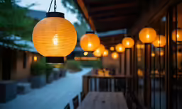 a group of orange lights in front of a restaurant