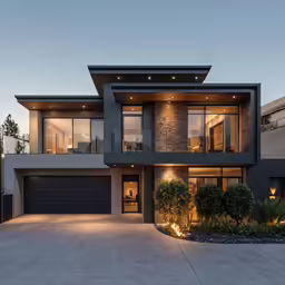 modern house with dark color and large front yard at dusk