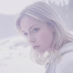 an attractive blond lady wearing white is looking into the camera