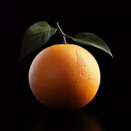 an orange on black background with a green leaf