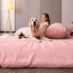 a girl that is laying down with a dog