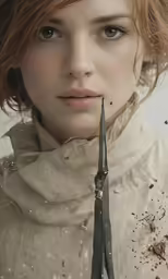 a young woman holding a pair of scissors in her hand