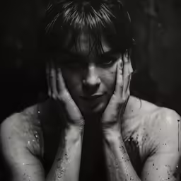 a man that has his hands on his face