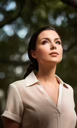 a beautiful woman posing for a picture under a tree