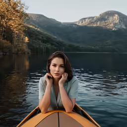a woman in a yellow boat on water