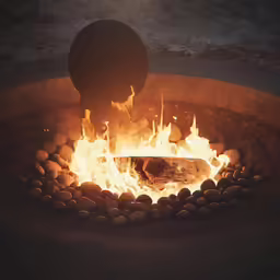 a fire pit that is full of pebbles and stones