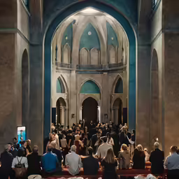 a group of people sitting on chairs in front of a cathedral