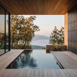 the view out of the inside of the house onto a pool