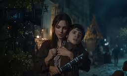 a couple is embracing each other near a street