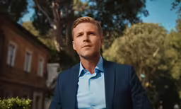 a young man in a blue shirt and jacket
