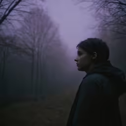 a woman in the fog in a park